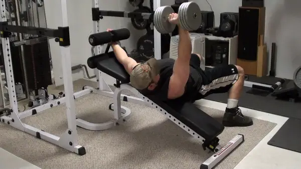 Work the inner pecs with tilted dumbbell bench press