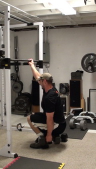 One-Arm Gripping Dumbbell Squats