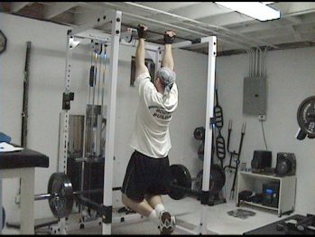 Hanging from a chin-up bar.