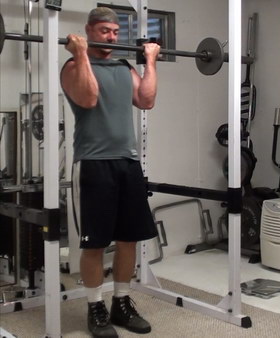 Rack-Leaning Barbell Curls to Wake Up Your Bicep Muscle Fibers