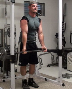 Rack-Leaning Barbell Curls to Wake Up Your Bicep Muscle Fibers