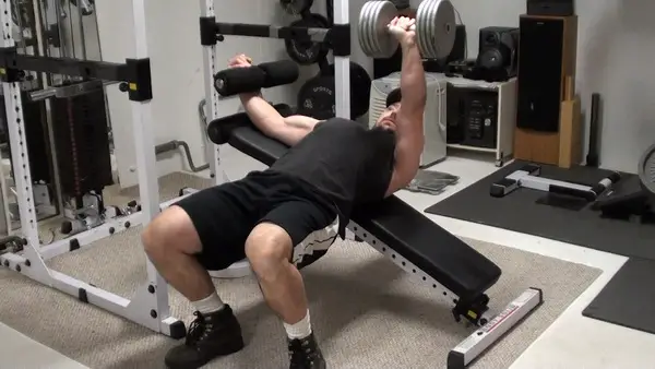 Work the inner pecs with tilted dumbbell bench press