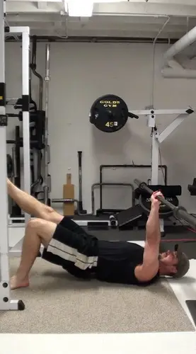 One-Arm Barbell Floor Press In Single-Leg Bridge Position