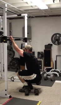 One-Arm Gripping Dumbbell Squats